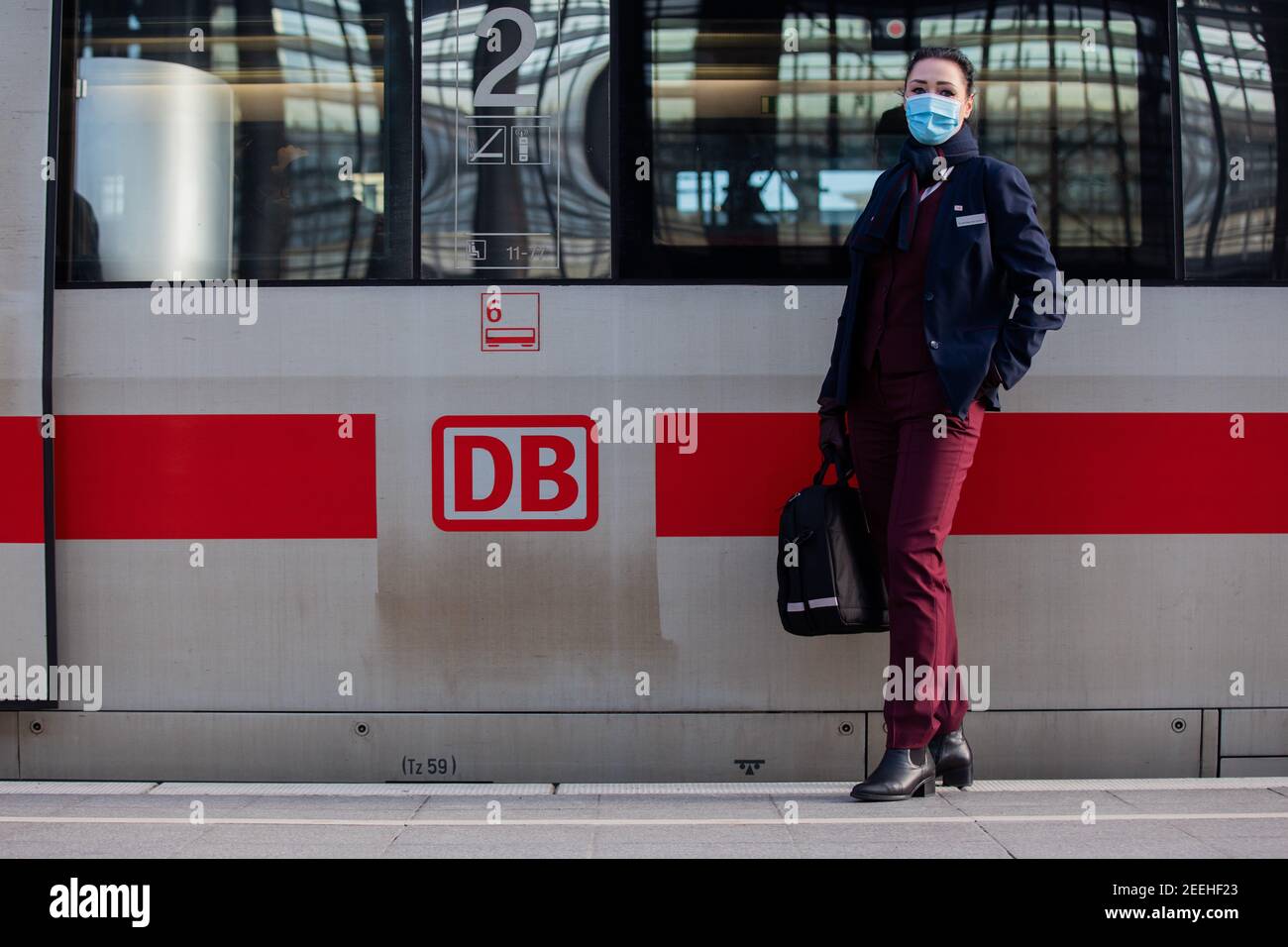 Cologne, Germany. 11th Feb, 2021. Nadine Perlinger dos Santos, former stewardess at Lufthansa subsidiary Germanwings and now a Deutsche Bahn train attendant, stands in front of an ICE train. Job prospects for pilots, flight attendants and aircraft technicians have deteriorated massively in the Corona crisis. In the reorientation, a state-owned company apparently offers advantages. (to dpa 'From the jet to the ICE - Flying personnel highly welcome at Bahn') Credit: Rolf Vennenbernd/dpa/Alamy Live News Stock Photo