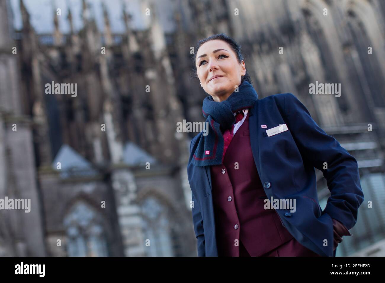 Cologne, Germany. 11th Feb, 2021. Nadine Perlinger dos Santos, former stewardess at Lufthansa subsidiary Germanwings and now a train attendant at Deutsche Bahn, is facing the dome. Job prospects for pilots, flight attendants and aircraft technicians have deteriorated massively in the Corona crisis. In the reorientation, a state-owned company apparently offers advantages. (to dpa 'From the jet to the ICE - Flying personnel highly welcome at Deutsche Bahn') Credit: Rolf Vennenbernd/dpa/Alamy Live News Stock Photo