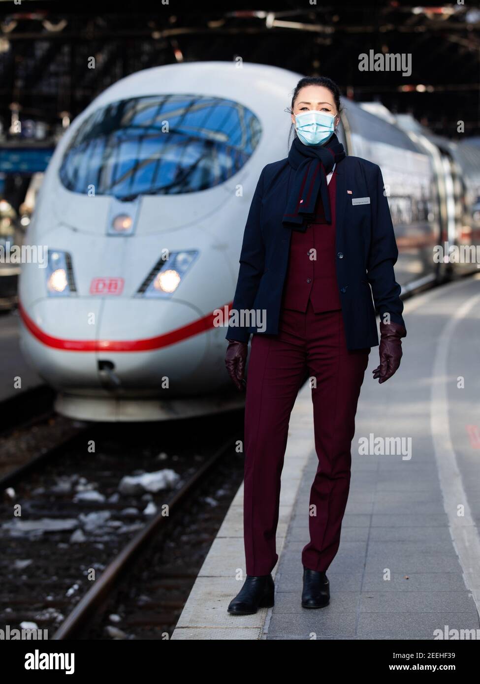 Cologne, Germany. 11th Feb, 2021. Nadine Perlinger dos Santos, former stewardess at Lufthansa subsidiary Germanwings and now a Deutsche Bahn train attendant, stands in front of an ICE train. Job prospects for pilots, flight attendants and aircraft technicians have deteriorated massively in the Corona crisis. In the reorientation, a state-owned company apparently offers advantages. (to dpa 'From the jet to the ICE - Flying personnel highly welcome at Bahn') Credit: Rolf Vennenbernd/dpa/Alamy Live News Stock Photo