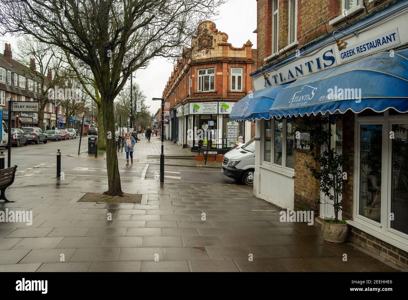 London- February, 2021: Pitshanger Lane, a suburban street of shops and houses in Ealing, west London Stock Photo