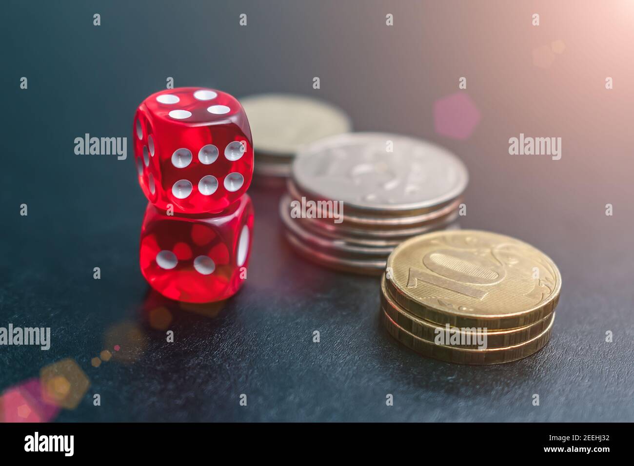 Dice, coins and chips of different denominations in the casino Stock Photo