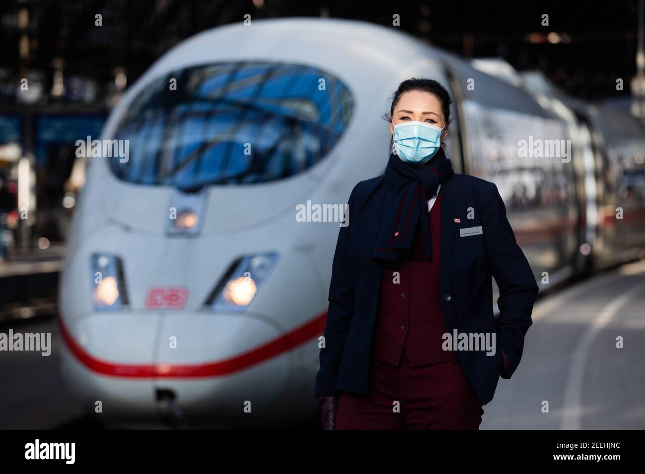 11 February 2021, North Rhine-Westphalia, Cologne: Nadine Perlinger dos Santos, former stewardess at Lufthansa subsidiary Germanwings and now a Deutsche Bahn train attendant, stands in front of an ICE train. Job prospects for pilots, flight attendants and aircraft technicians have deteriorated massively in the Corona crisis. In the reorientation, a state-owned company apparently offers advantages.        (to dpa 'From the jet to the ICE - Flying personnel highly welcome at Bahn') Photo: Rolf Vennenbernd/dpa Stock Photo