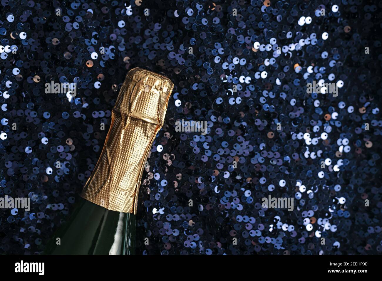 Champagne bottle with bright paillettes decor Stock Photo