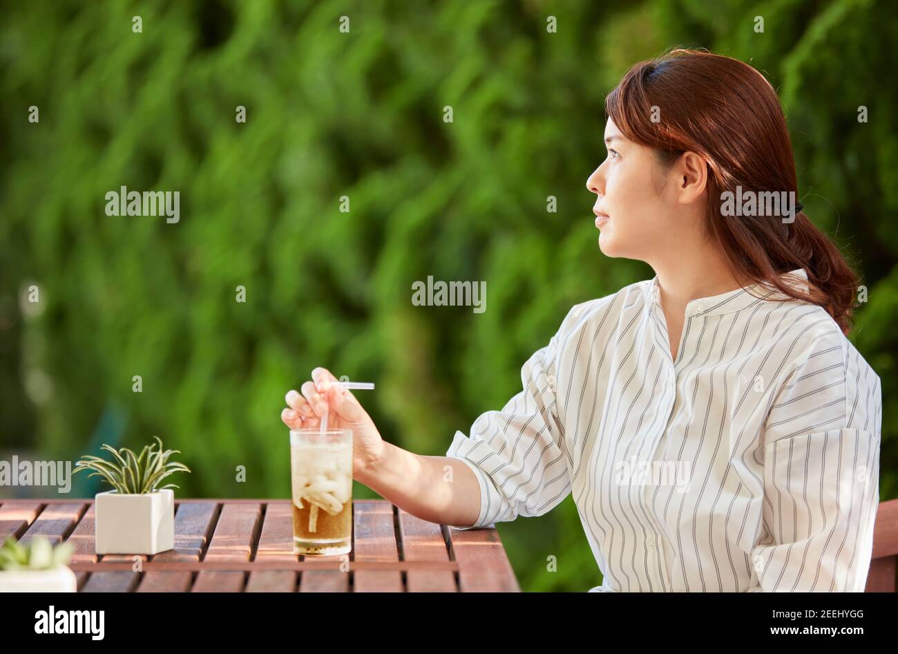 Japanese woman relaxing in the garden Stock Photo - Alamy