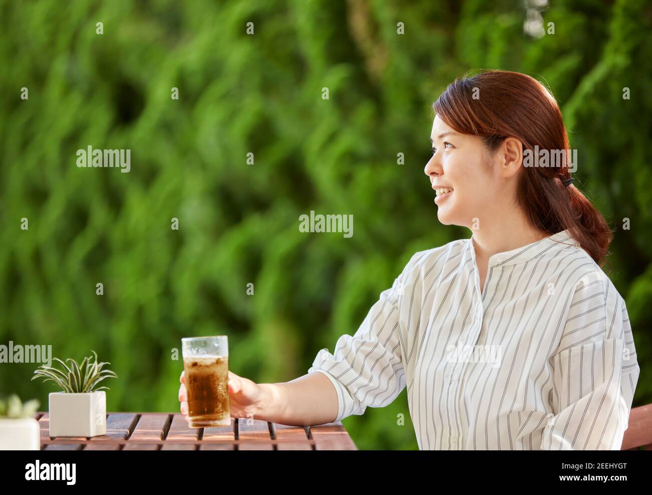 Japanese woman relaxing in the garden Stock Photo - Alamy