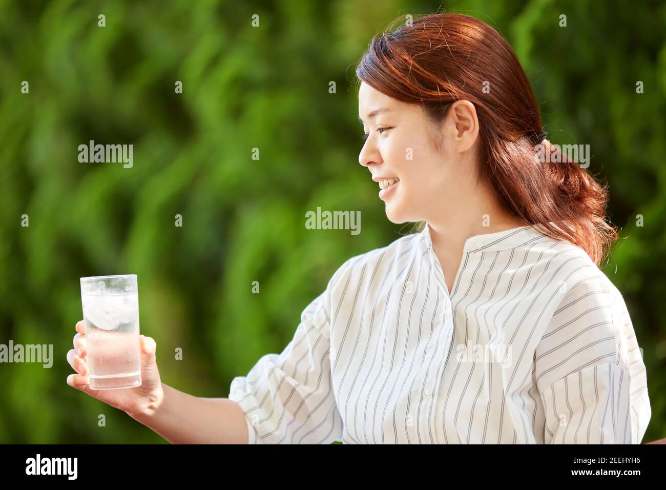 Japanese woman relaxing in the garden Stock Photo - Alamy