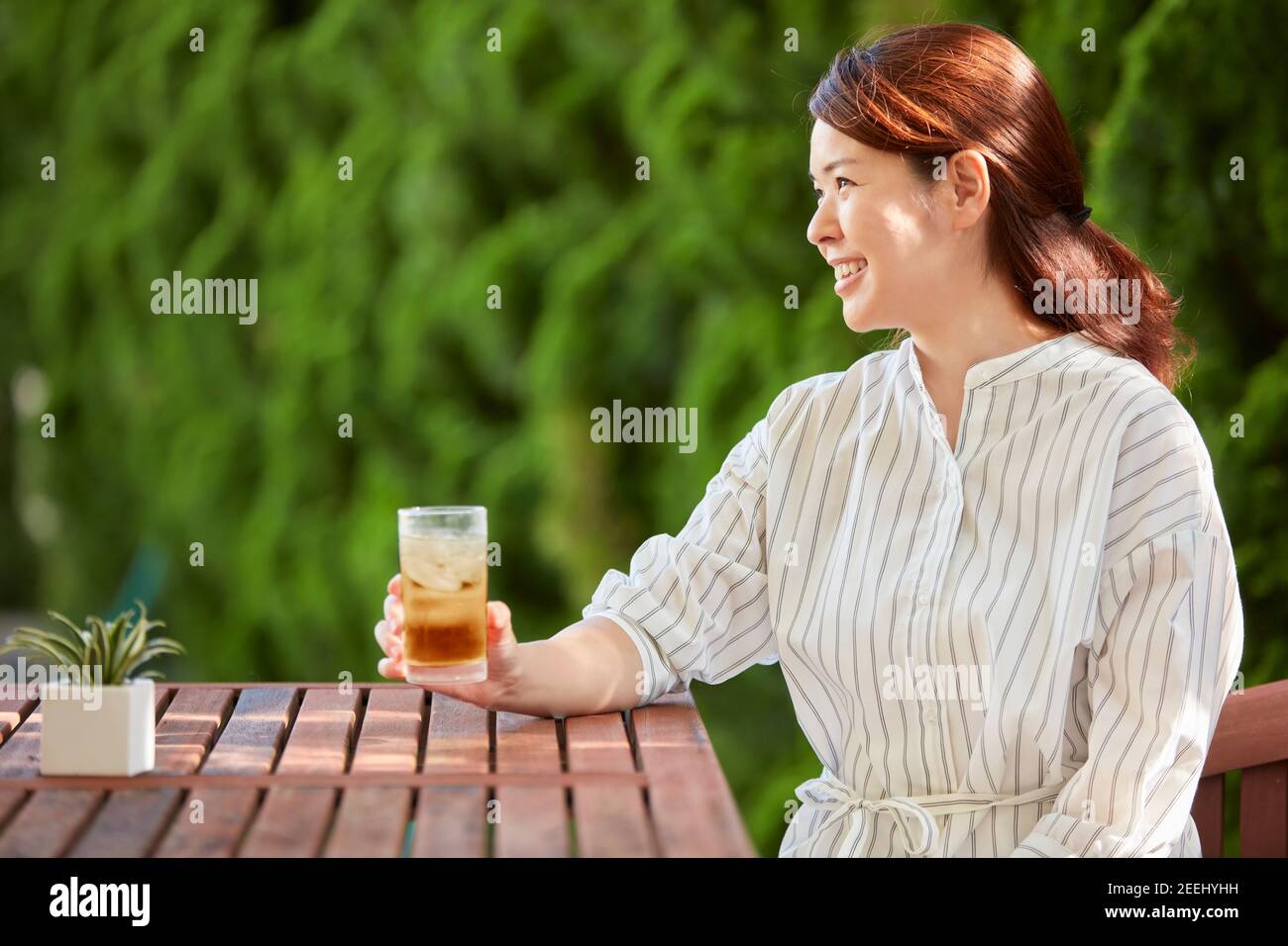 Japanese woman relaxing in the garden Stock Photo - Alamy