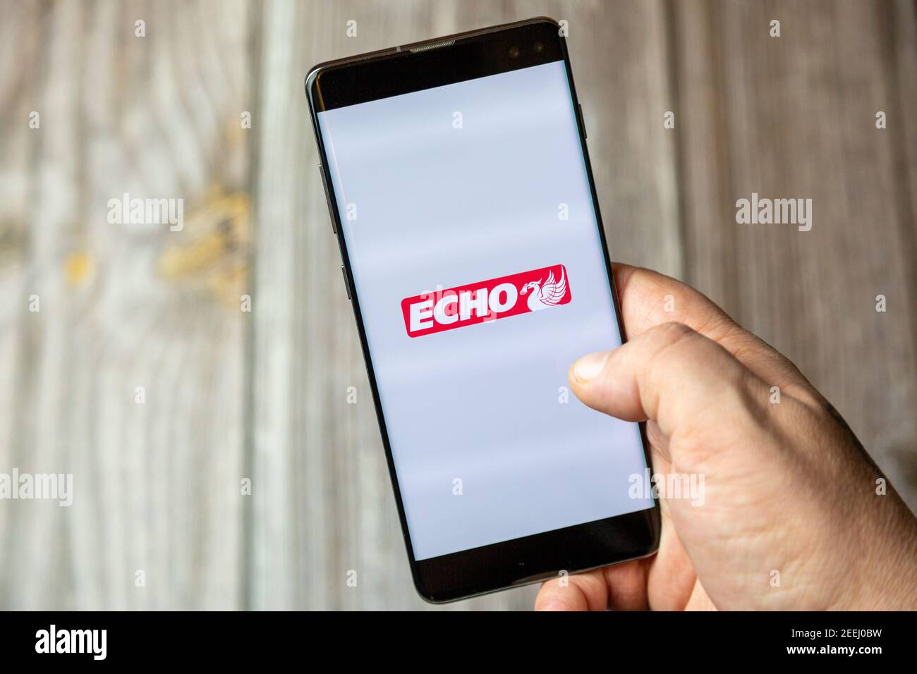 A mobile phone or cell phone being held in a hand with the Liverpool