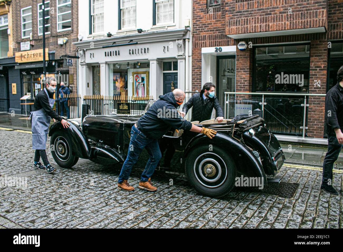 BONHAMS LONDON, UK 16 February 2021. Staff rollout the  1937 Bugatti Type 57S, one of the world’s most valuable and desirable pre-war motor cars, with an estimate of £5,000,000 - 7,000,000 which has been hidden for the past 50 years is offered for the first time at auction. It was owned by  Sir Malcolm Campbell, of the ‘Bluebird’ world land and water speed records fame, only 42 examples of the 57S variants were produced and it was the fastest road car of its day. Credit amer ghazzal/Alamy Live News Stock Photo
