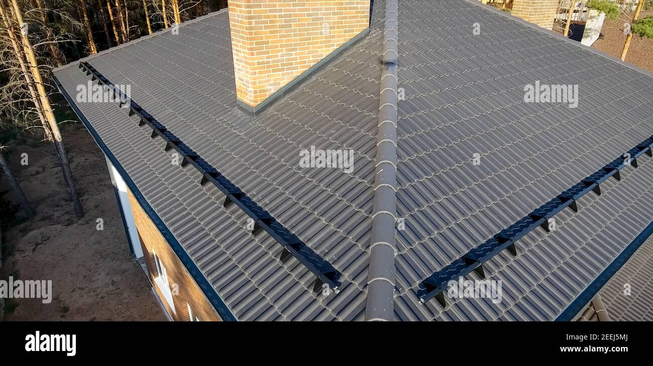 House with a ceramic tile roof. cementsand roof tiles Stock Photo Alamy