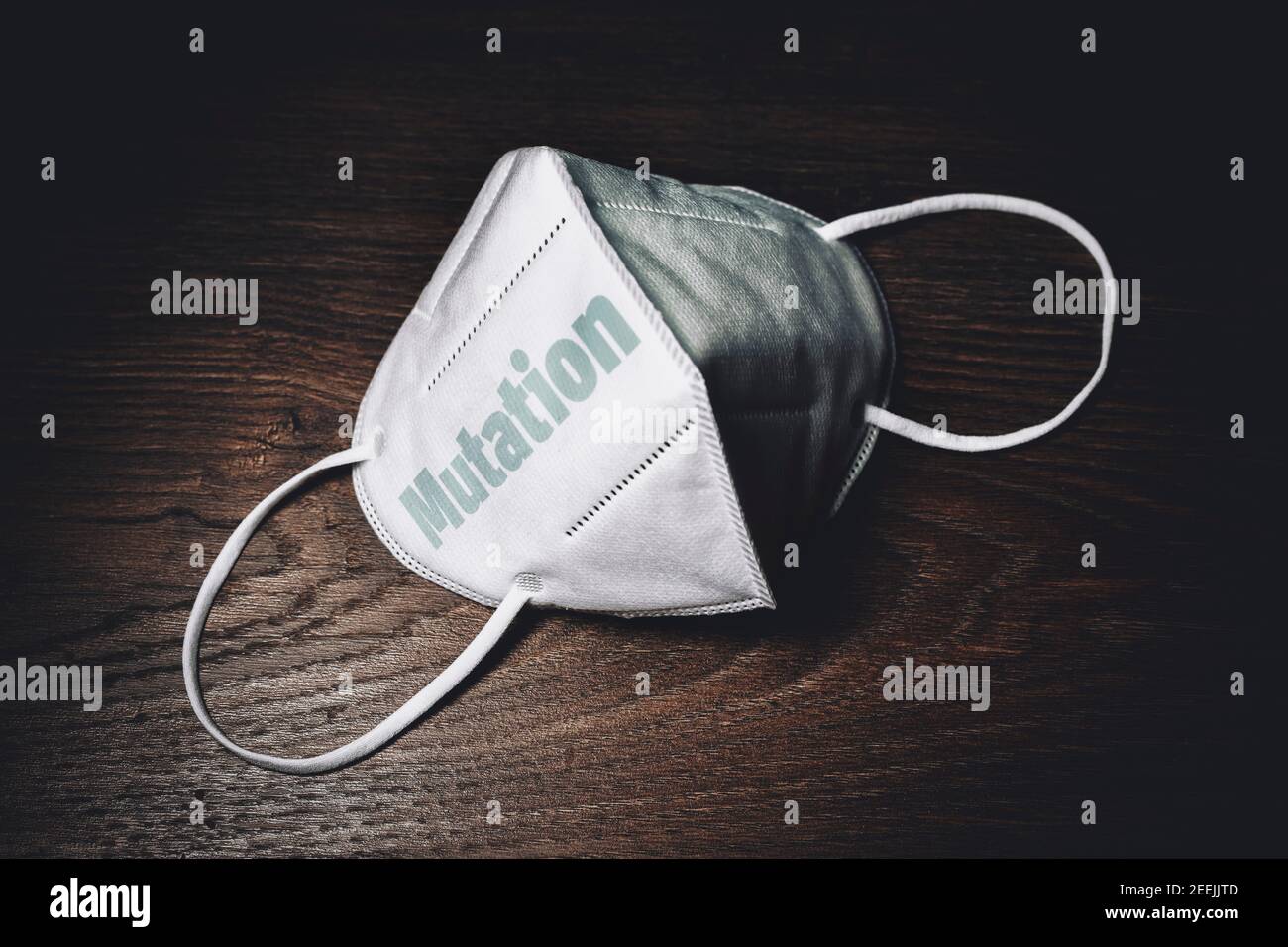FFP2 Face Mask On A Table, Mutation Lettering, Virus Mutations Stock Photo