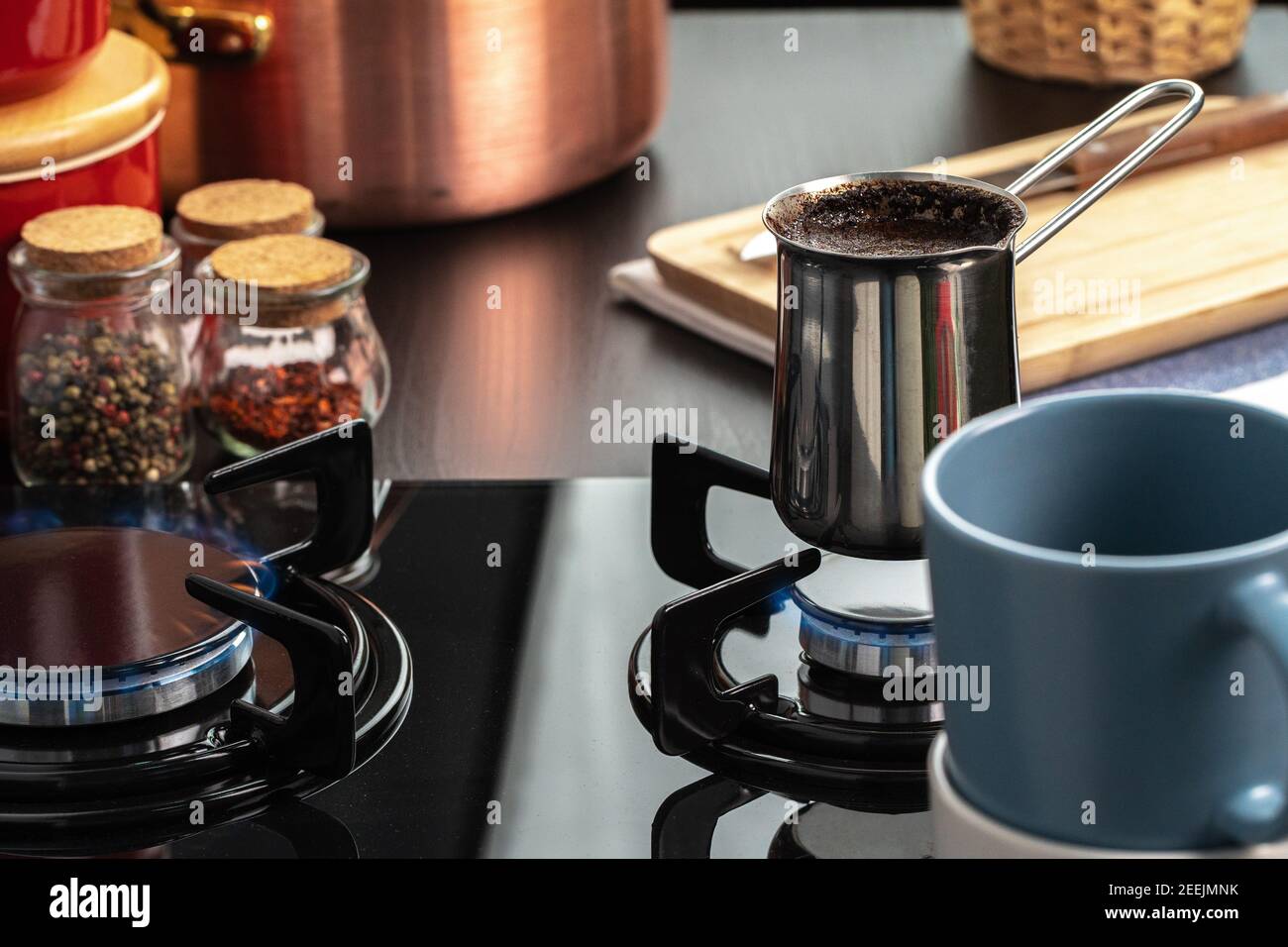 Brew coffee in a steel turk on a gas stove Stock Photo Alamy