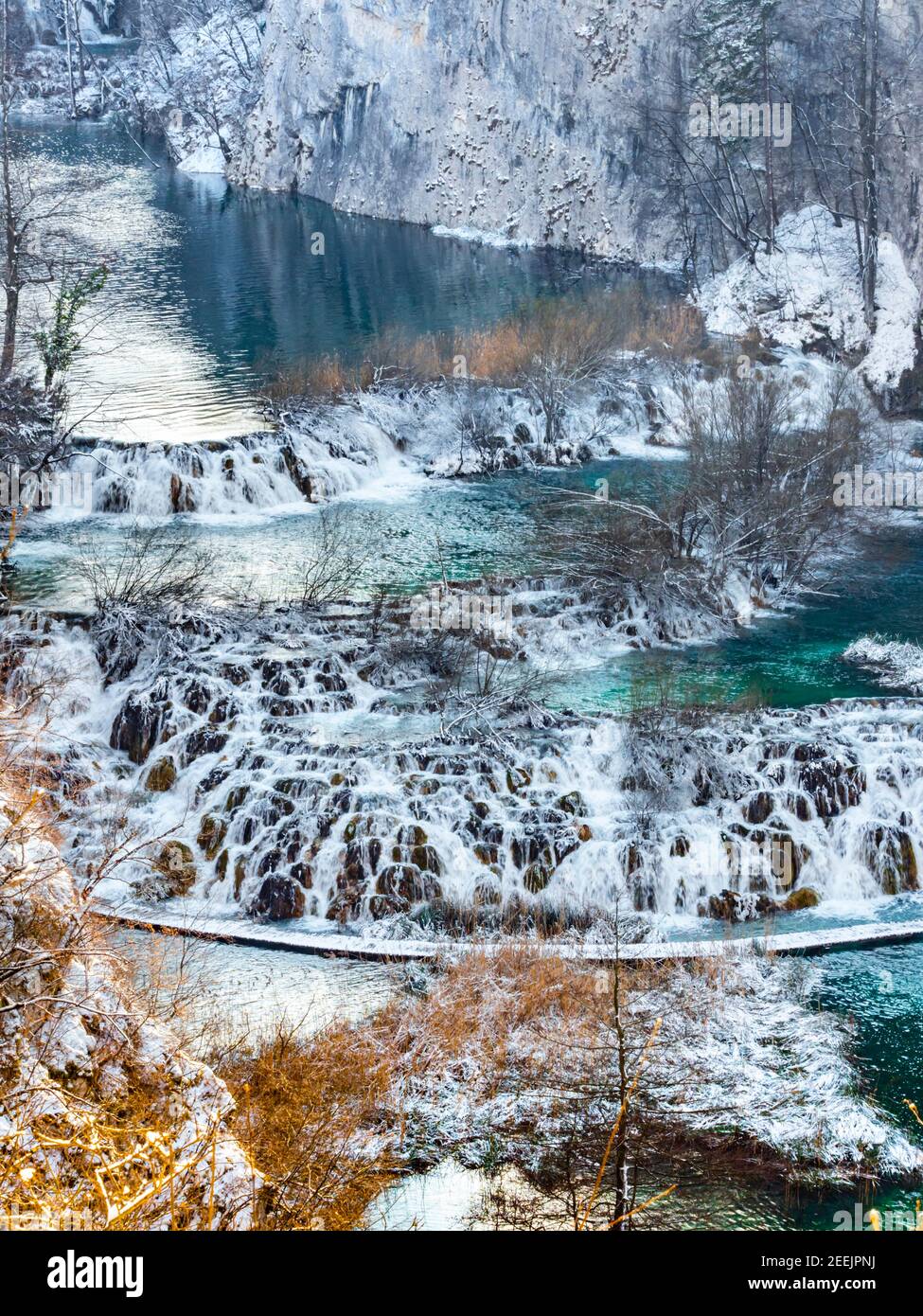 Cascading waterfalls in national park Plitvice lakes Croatia Europe Winter under covered cover snow ice waterflow water flowing flow Stock Photo