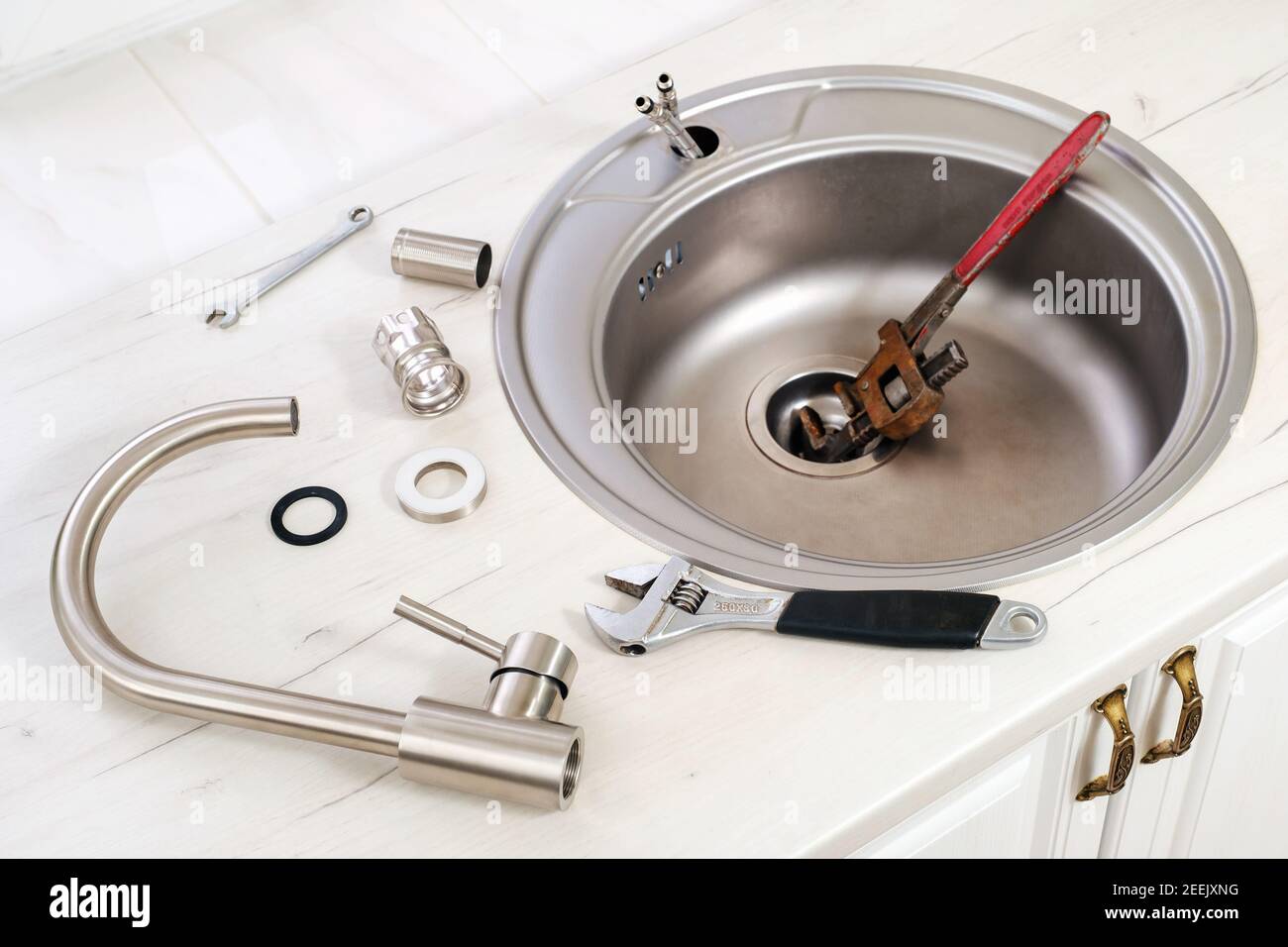New faucet and tools for installing into the kitchen sink Stock Photo