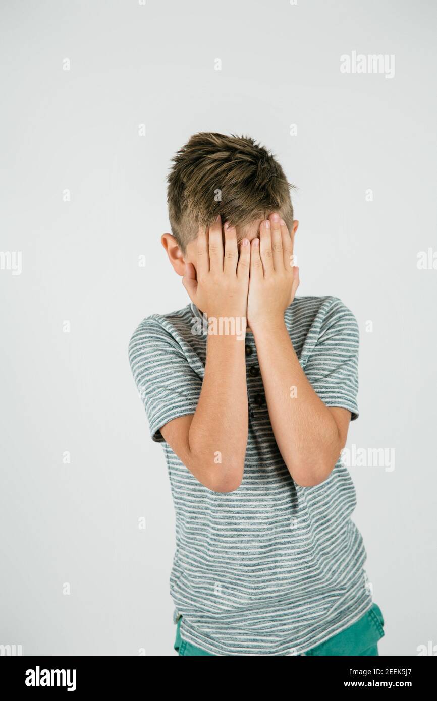 Little boy with his hands covering his eyes Stock Photo - Alamy