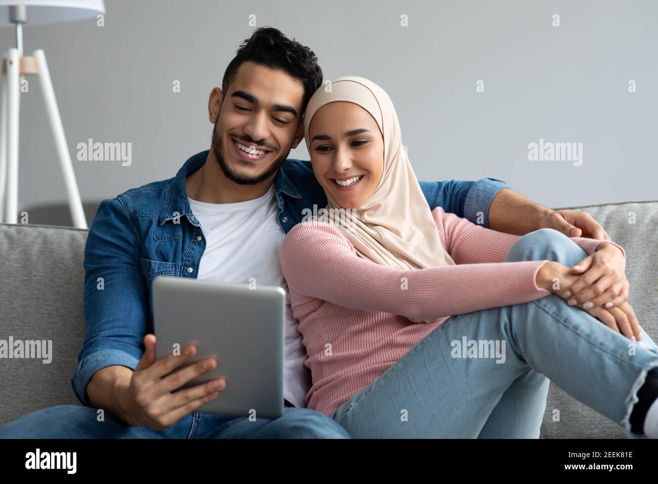 Happy middle-eastern couple looking at digital tablet screen Stock Photo