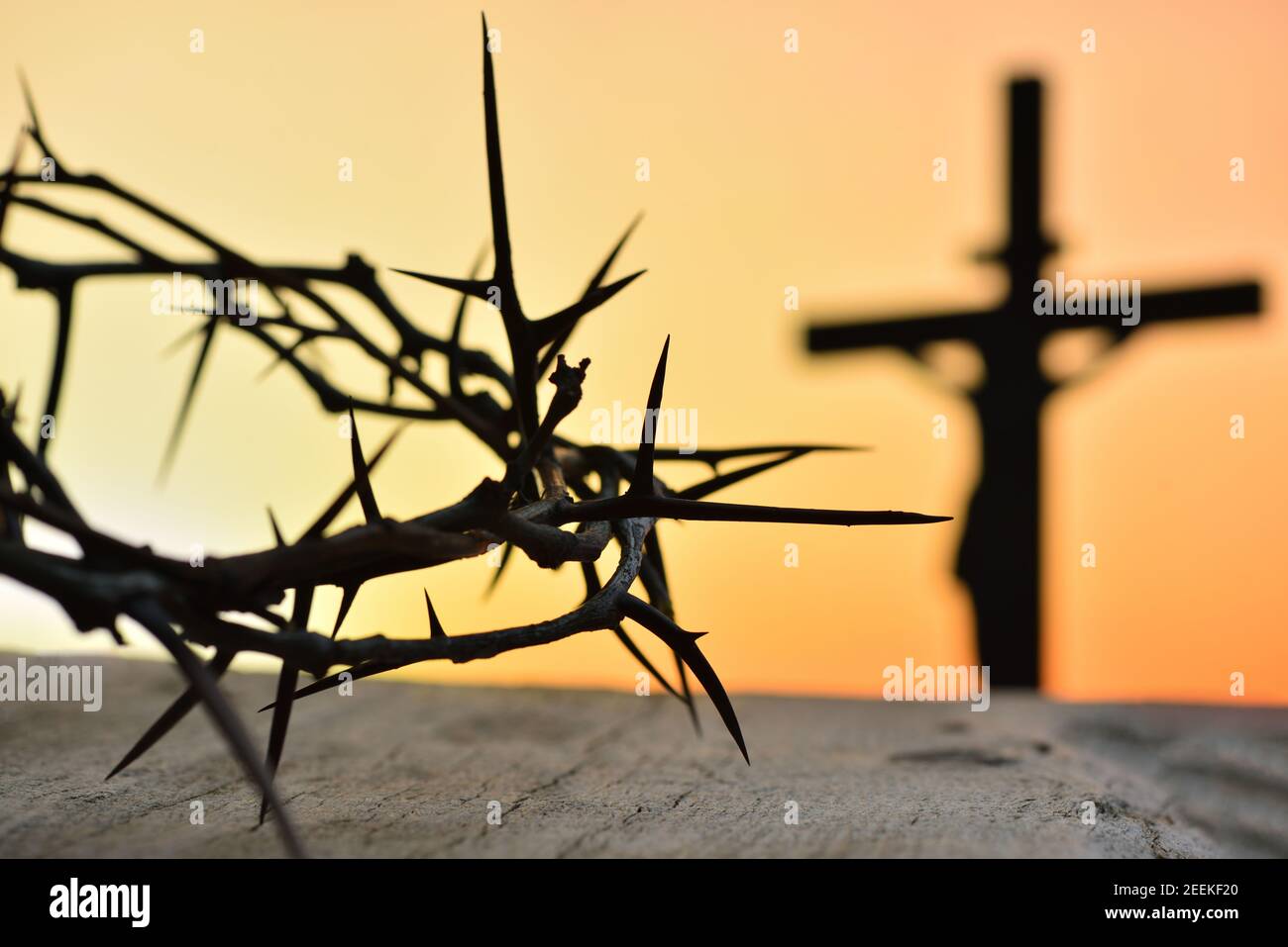 Crown of thorns of Jesus Christ against silhouette of catholic cross at  sunset background Stock Photo - Alamy
