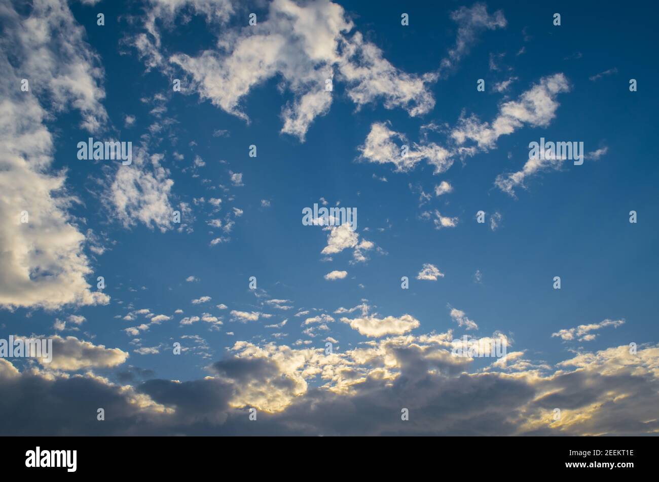 Blue sky with fluffy clouds in a bright sunny day Stock Photo - Alamy