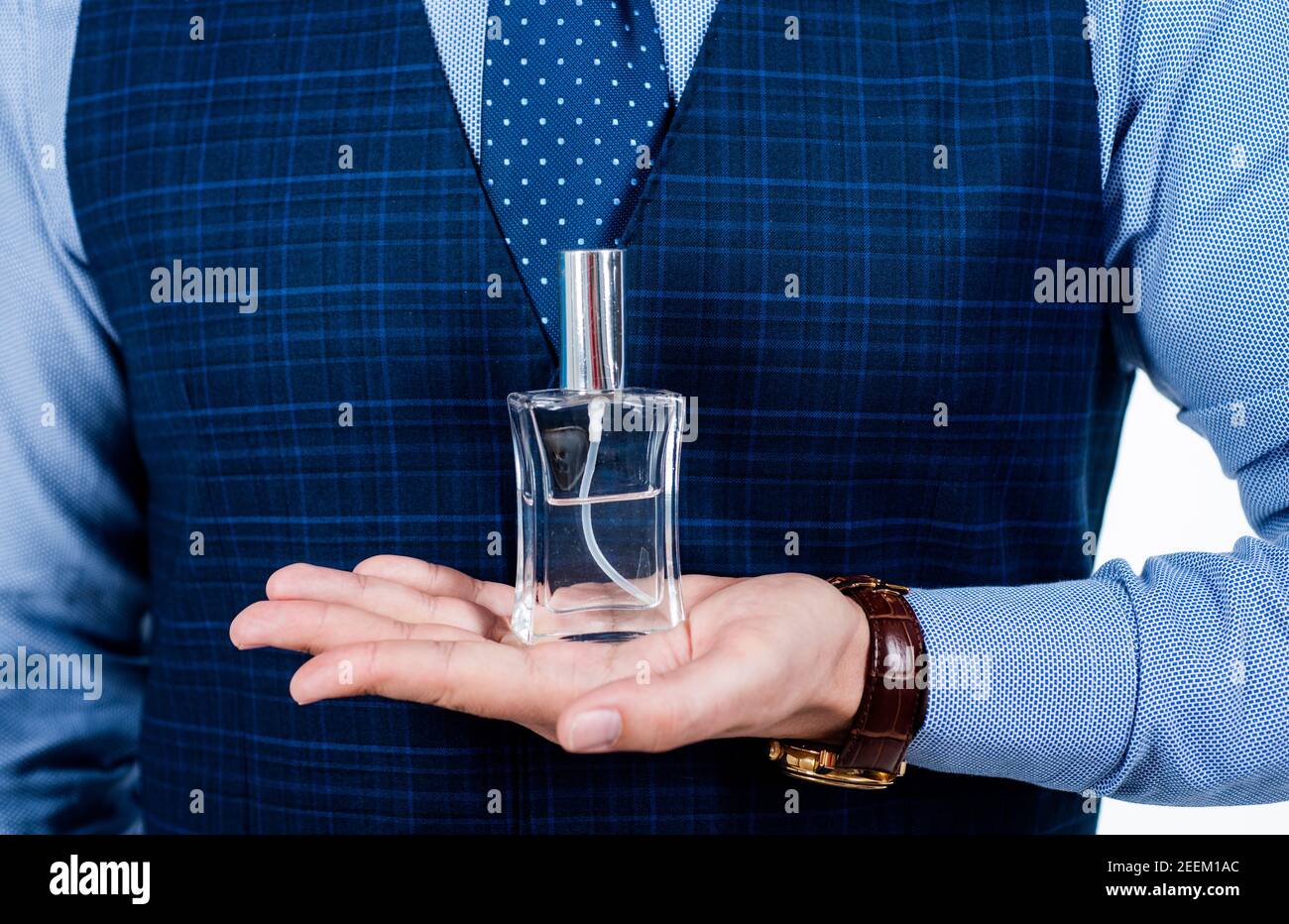 cologne for men. Perfumer shop assistant guy presenting product. Man perfume and fragrance. advertisement and announcement. Cologne bottle. male beauty and fashion. Masculine perfume. Stock Photo