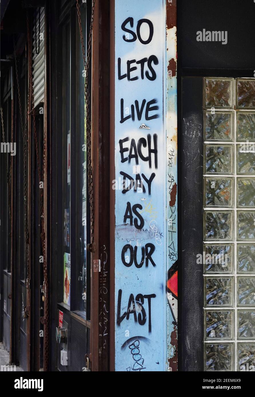 so lets live each day as our last saying on wall of shop in Brooklyn NYC Stock Photo