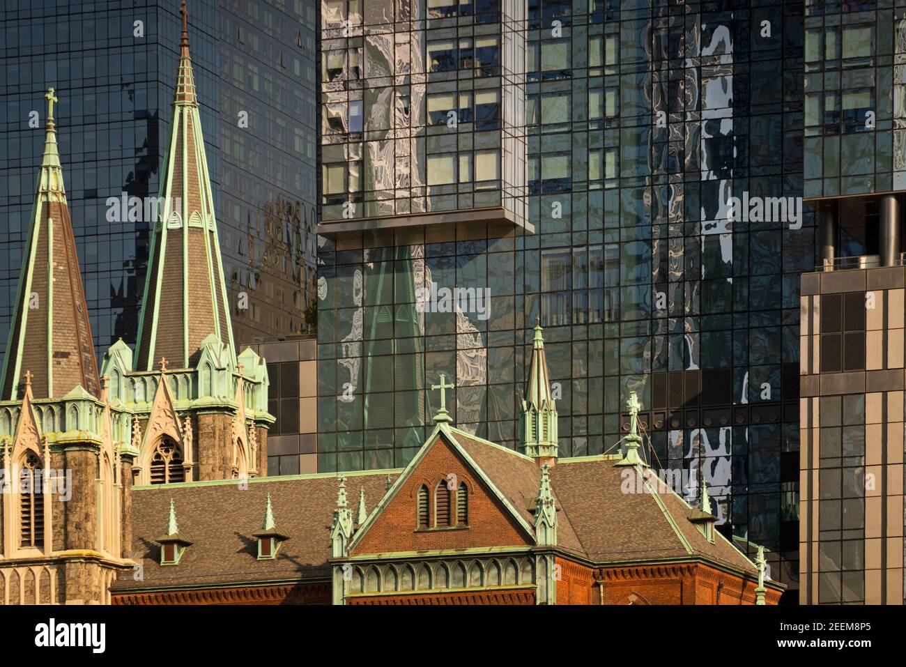 church next to new glass buildings on westside of Manhattan NYC Stock Photo