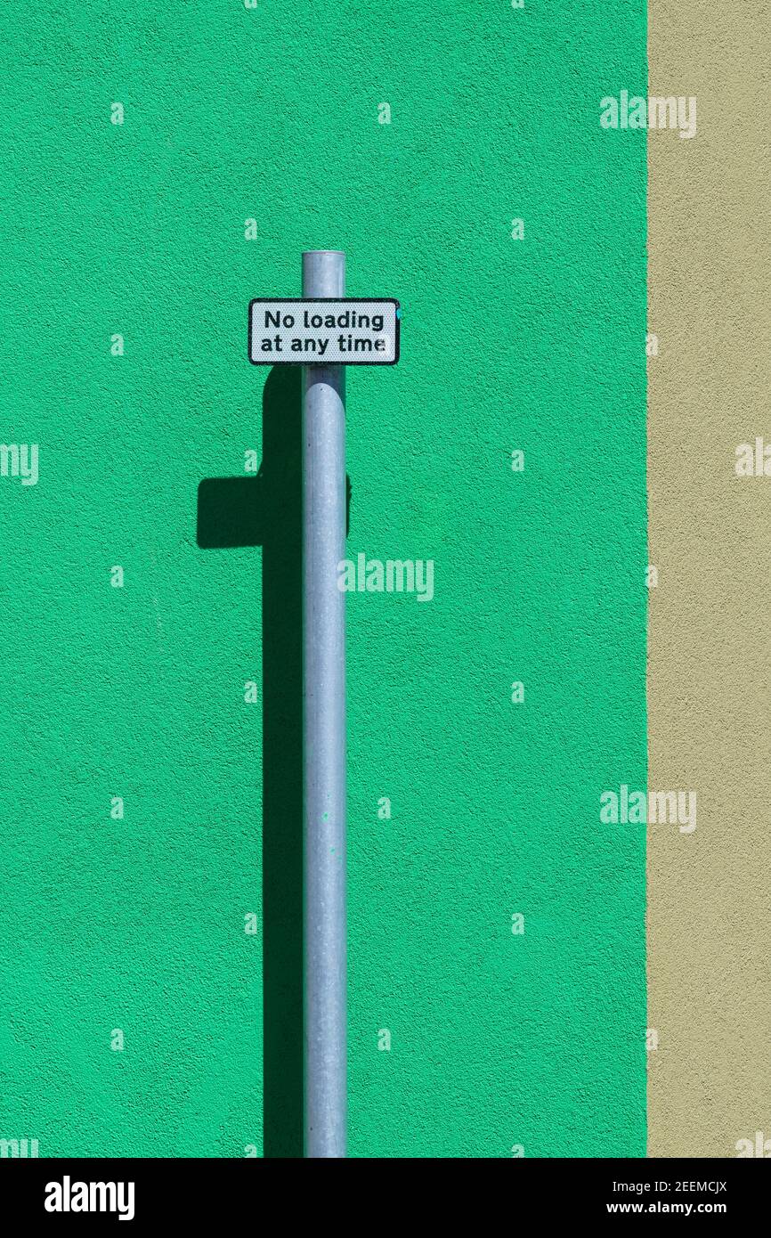 No Loading at any time signpost against colourful background Stock Photo