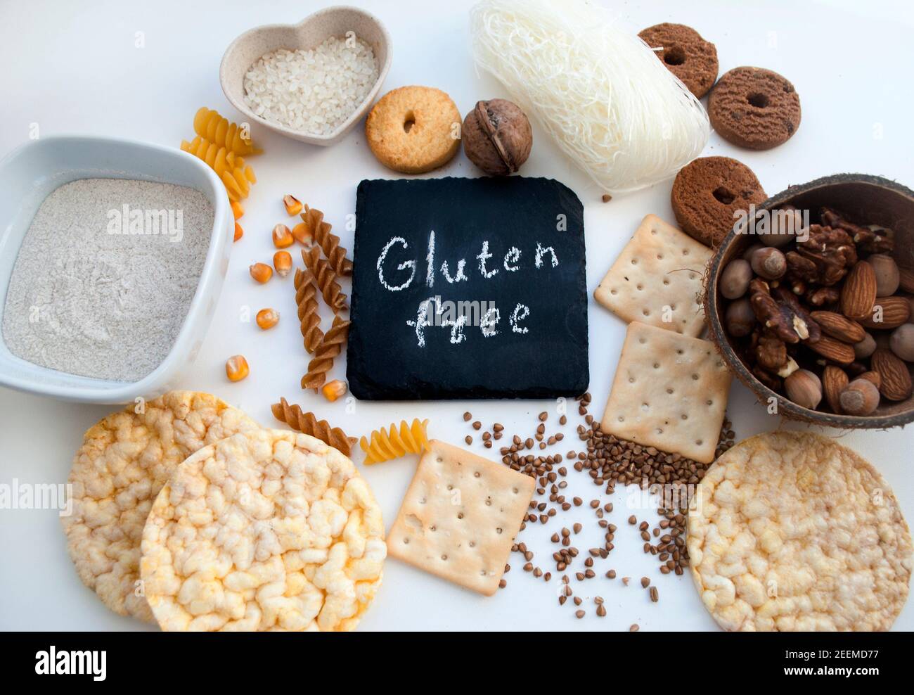Gluten free (sans gluten) sign handwritten on a chalk board surrounded by ingrediients close up
