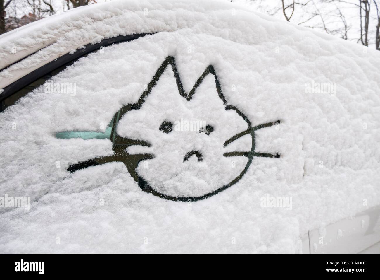 Wintereinbruch in Berlin im Februar 2021 . Verschneite Autos in Kreuzberg, Katze in Schnee auf Autoscheibe gemalt. Kältewelle, Russenpeitsche, eisige Stock Photo