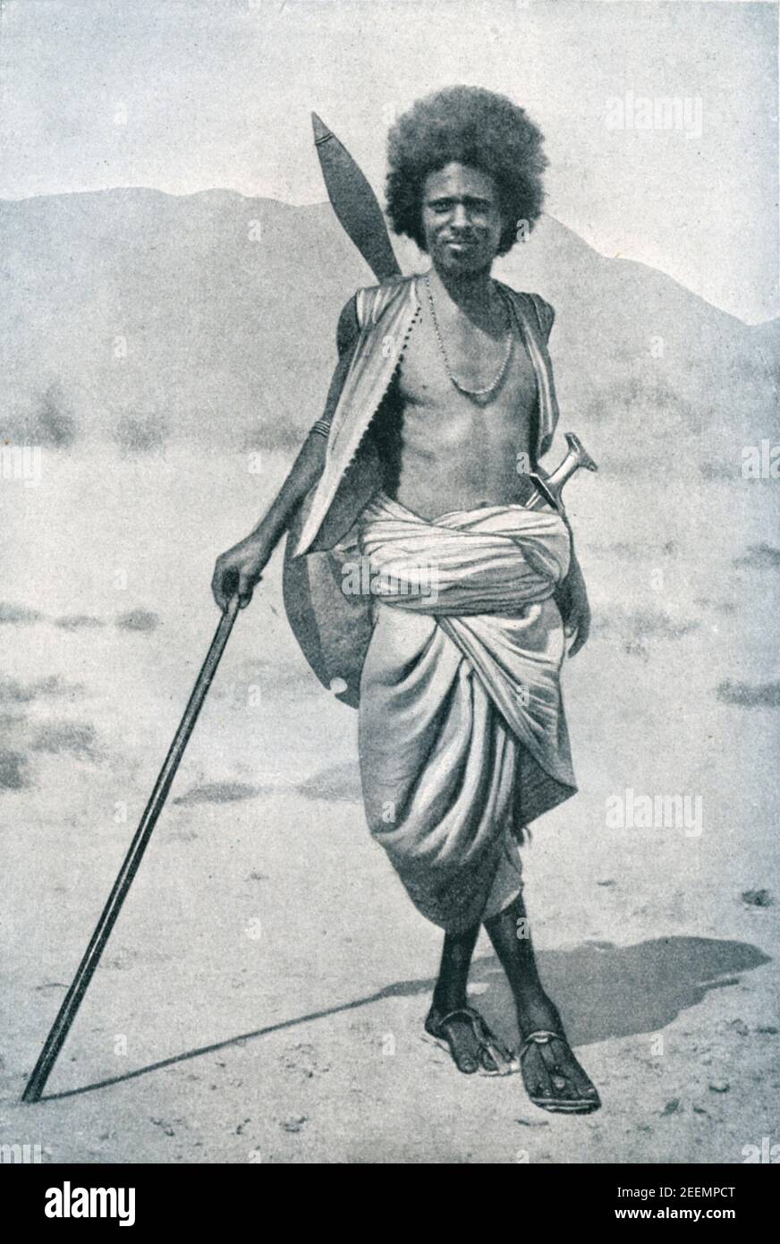 Early 20th century photo of member of the Hadendoa Beja nomadic tribe of eastern Sudan armed with spear, sword and shield. Their hair style (tiffa) gained them the nick name Fuzzy Wuzzy among British troops during the Mahdist War of the 1880-1890s Stock Photo