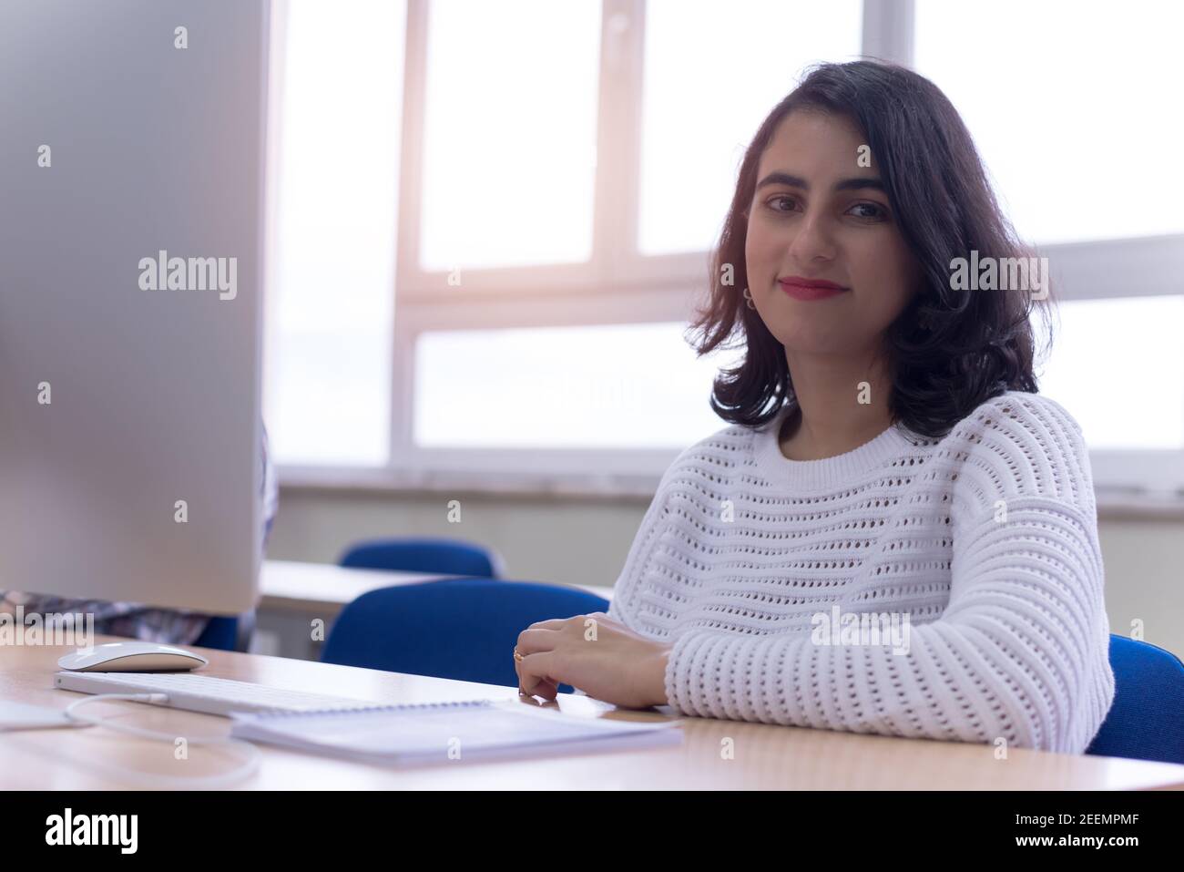 Beautiful female IT student working at her computer lab. Female student ...