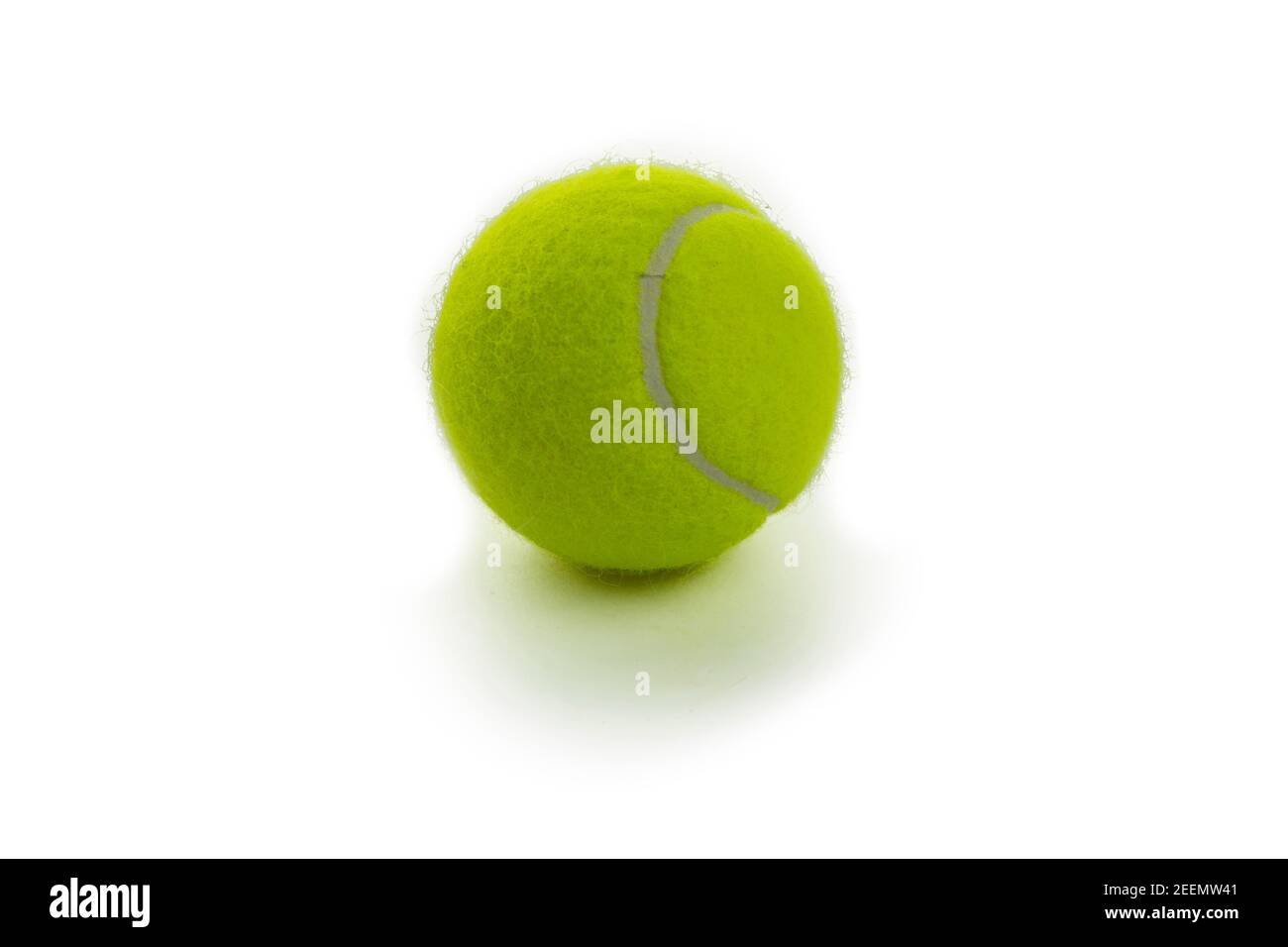 on a white background lies an isolated yellow tennis ball Stock Photo