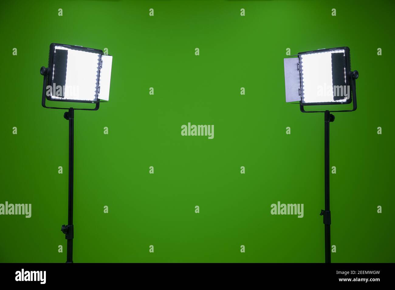 Green screen television studio with two fill lights. Lights are on in chroma studio Stock Photo