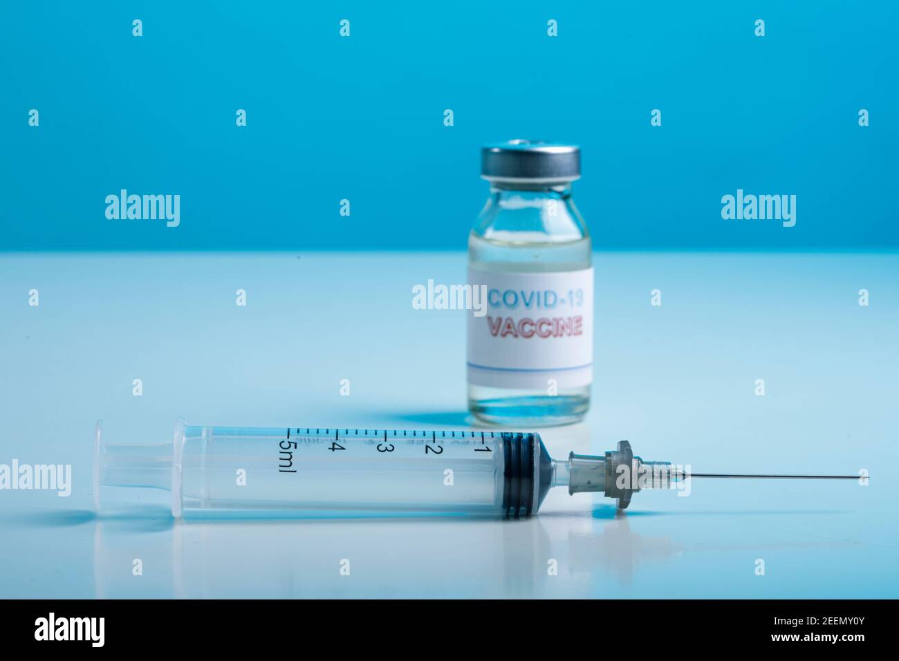 Coronavirus Vaccine Bottle with Syringe, Isolated on Colored Background Stock Photo