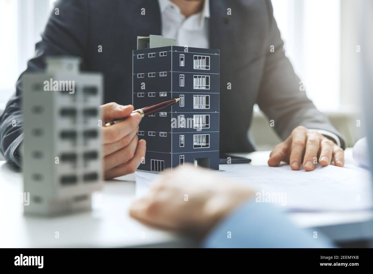 real estate developer and architect discussing new housing development project in office Stock Photo