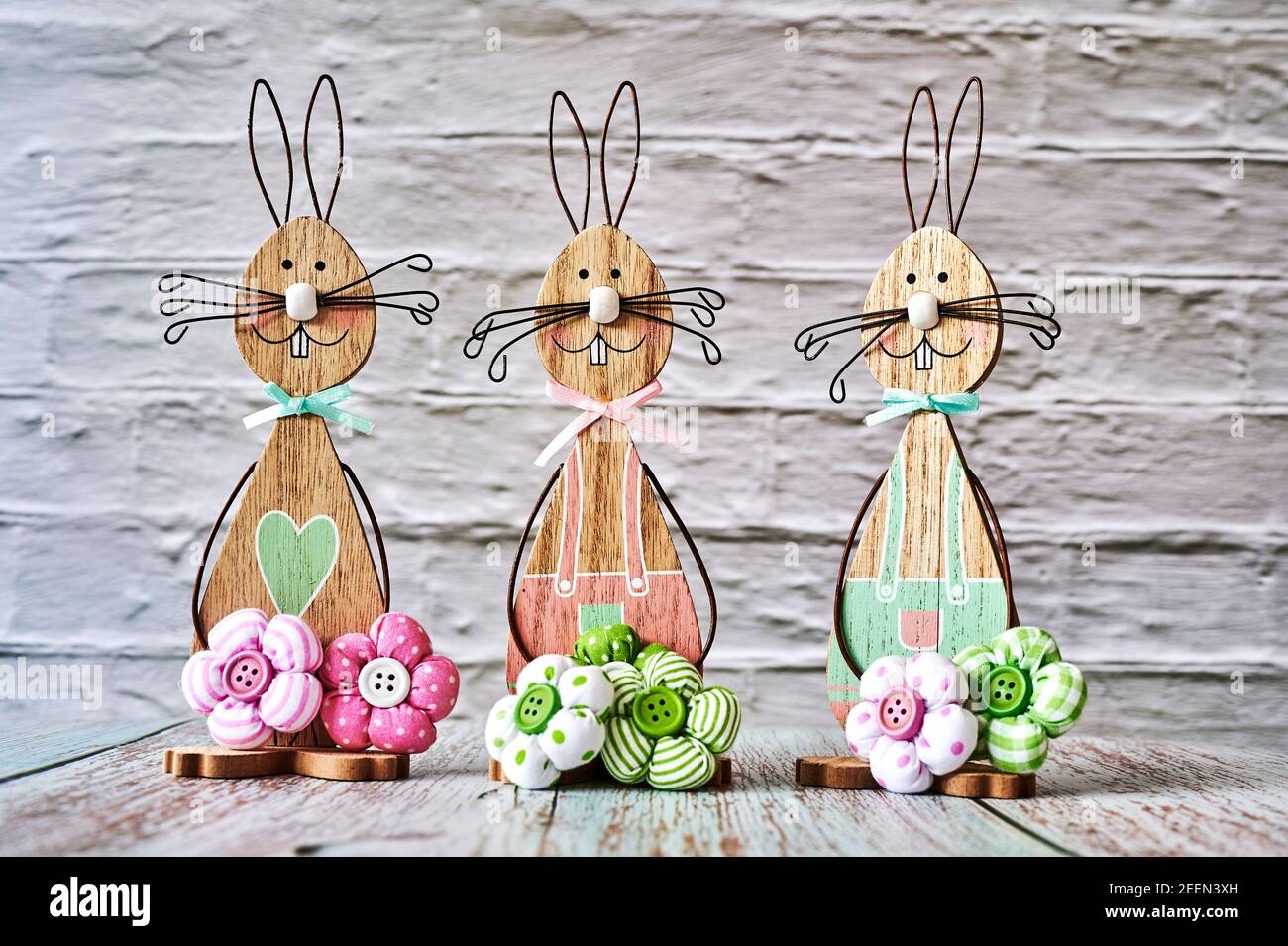 Three wooden Easter bunnies with decoration. Stock Photo