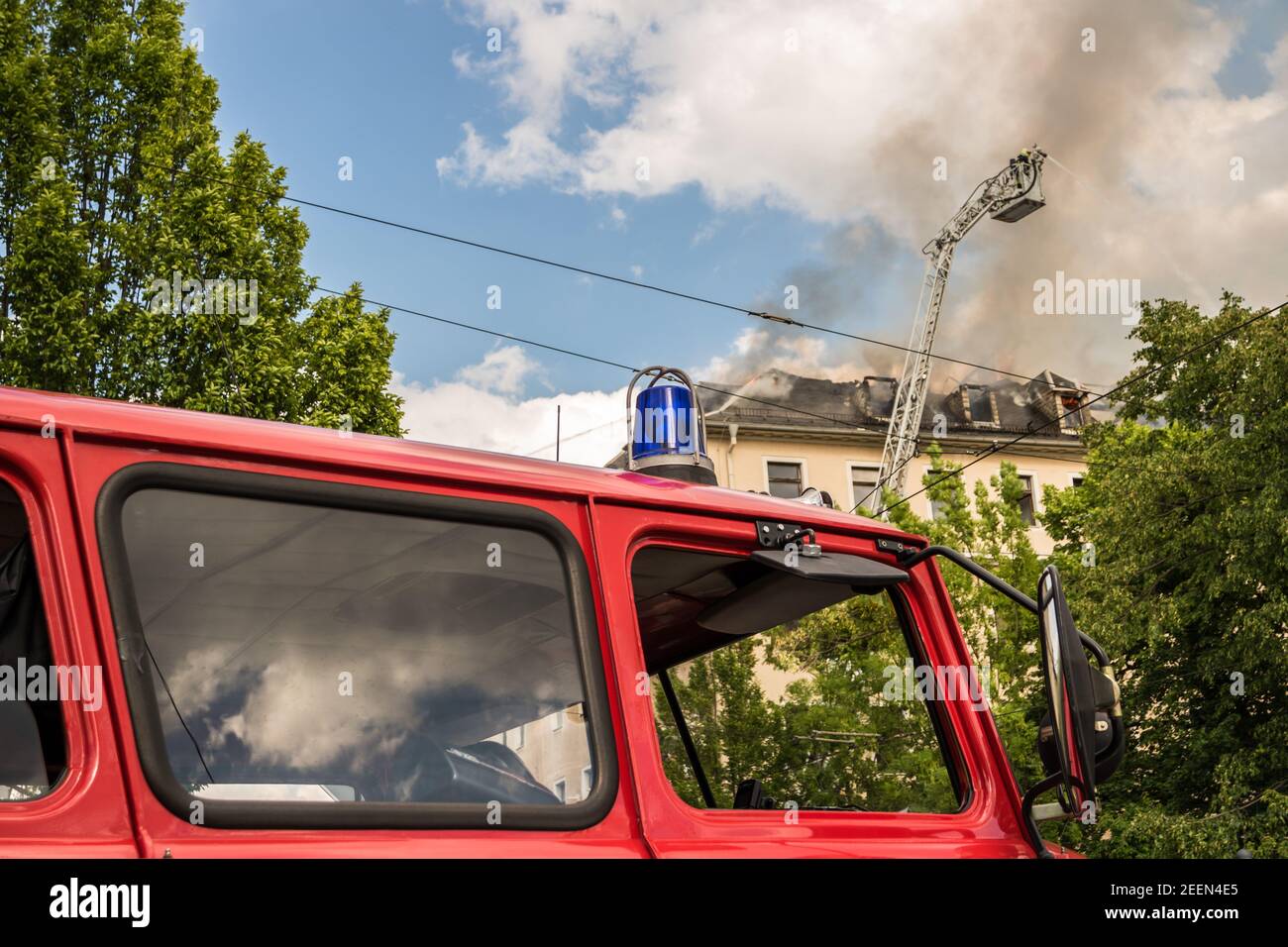 Fire department stands in front of a burning house Stock Photo - Alamy