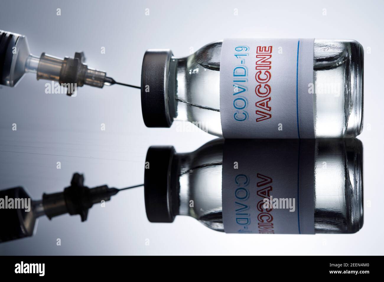 drawing of the anti-covid vaccine with a syringe from a glass fillet, isolated on reflective background Stock Photo