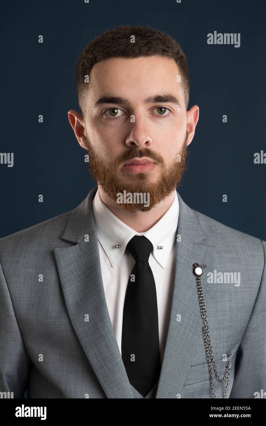 Portrait of a young business man wearing a grey suit Stock Photo