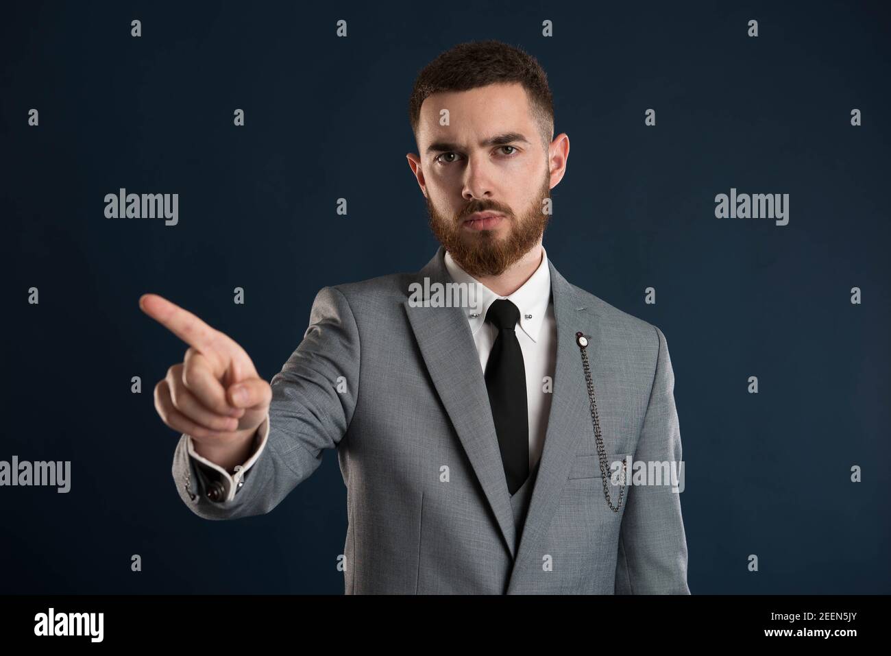 Upset businessman saying no wearing a grey jacket and black tie Stock Photo