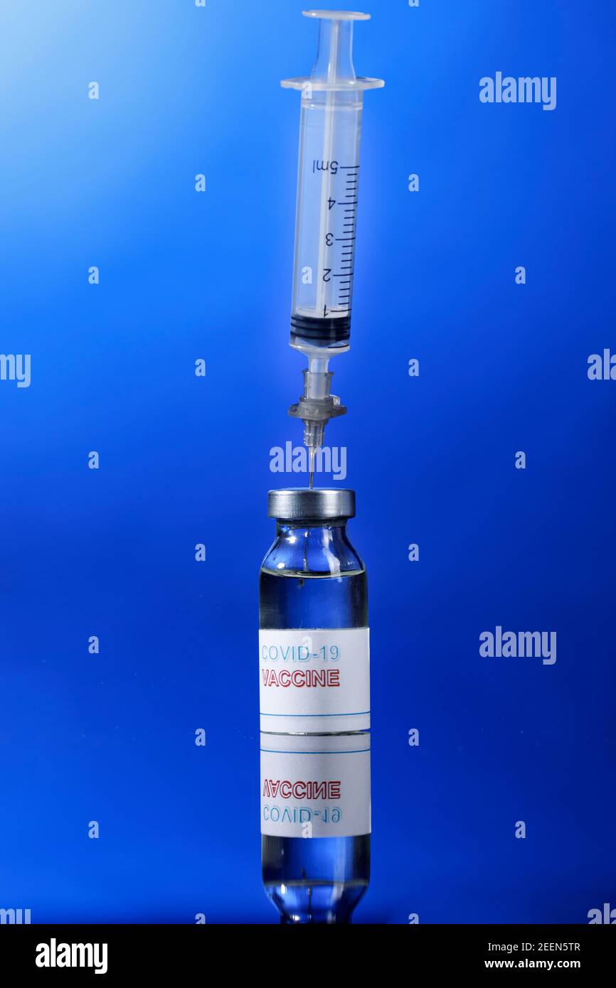 drawing of the anti-covid vaccine with a syringe from a glass fillet, isolated on reflective background Stock Photo