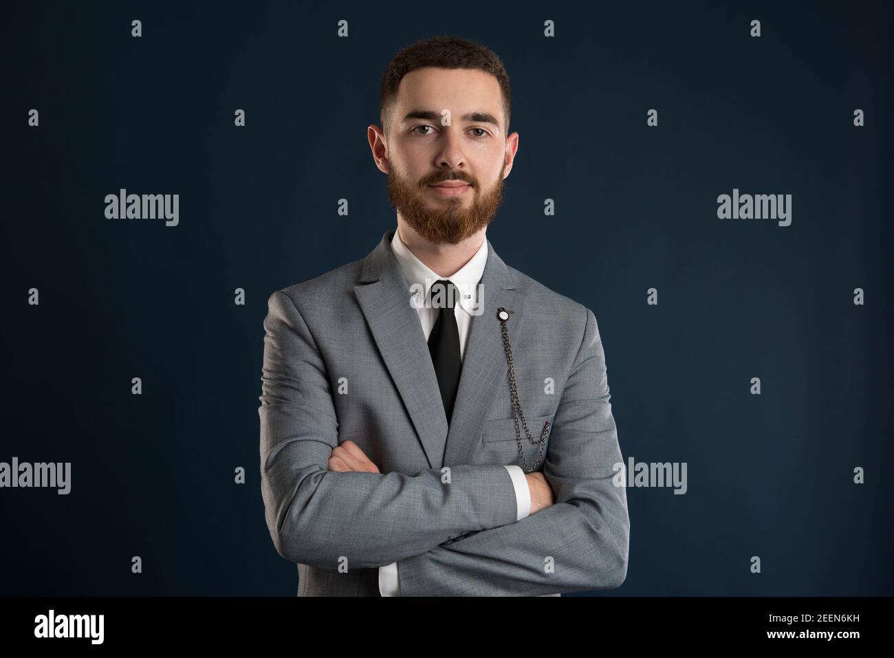 Portrait of a handsome businessman wearing a grey jacket and a black tie Stock Photo