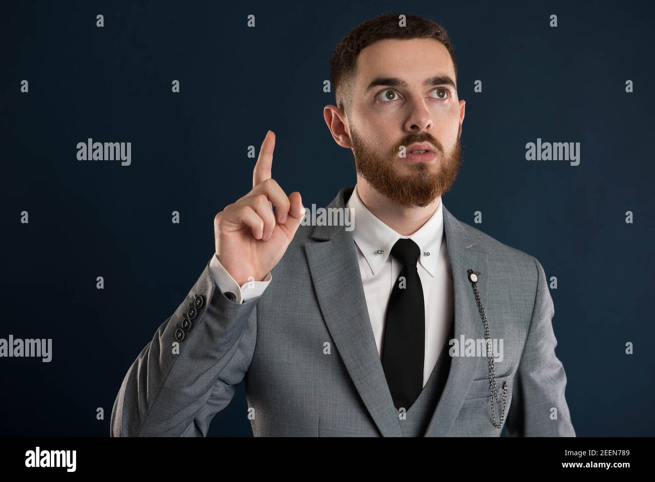 Handsome young businessman  having a great ideea wearing a grey suit and black tie Stock Photo