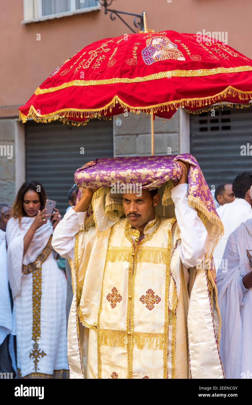 People enjoy taking apart in an Eritrean Church religious festival wearing religious clothes, playing music and dancing in the streets of Bologna Ital Stock Photo