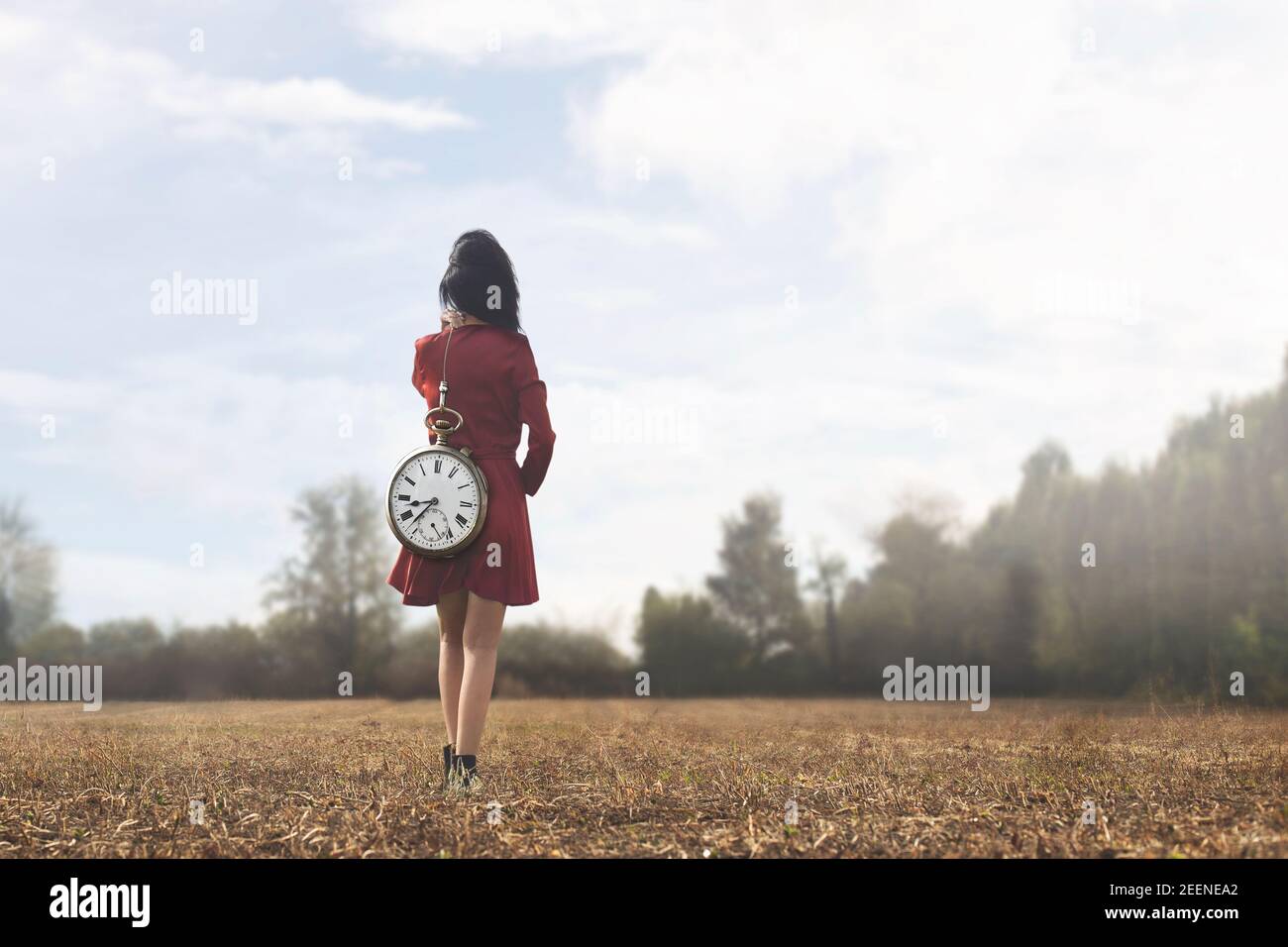 surreal moment of a woman who is walking towards her destiny with the weight of time passing Stock Photo