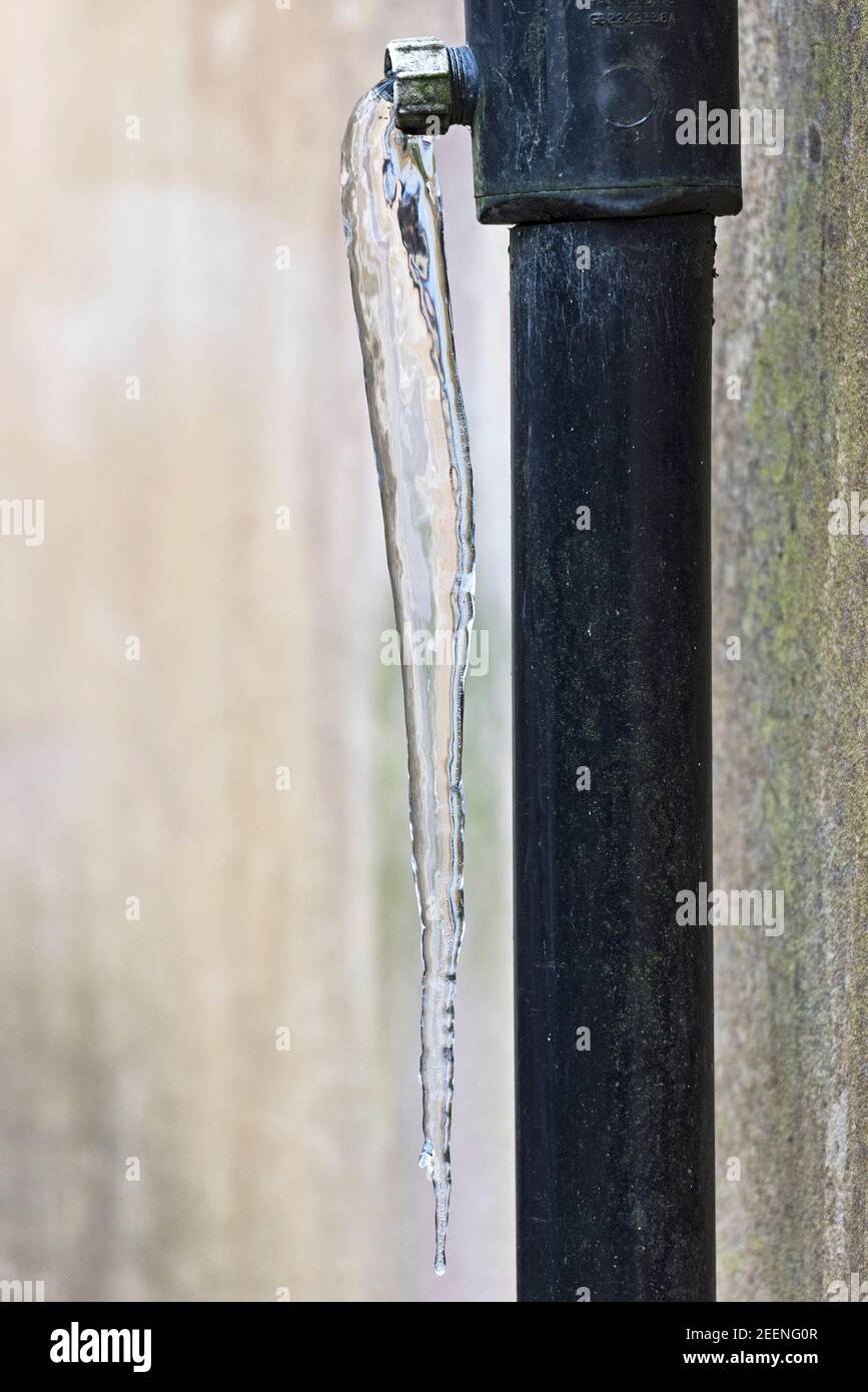 An Icicle Hangs From A Downpipe During A Period Of Bitter Cold Weather UK Stock Photo Alamy
