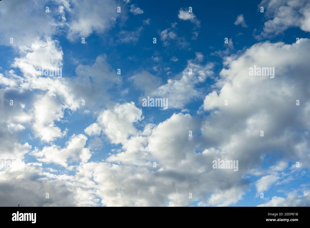 Clouds moving on blue sky forming a storm. Stock Photo