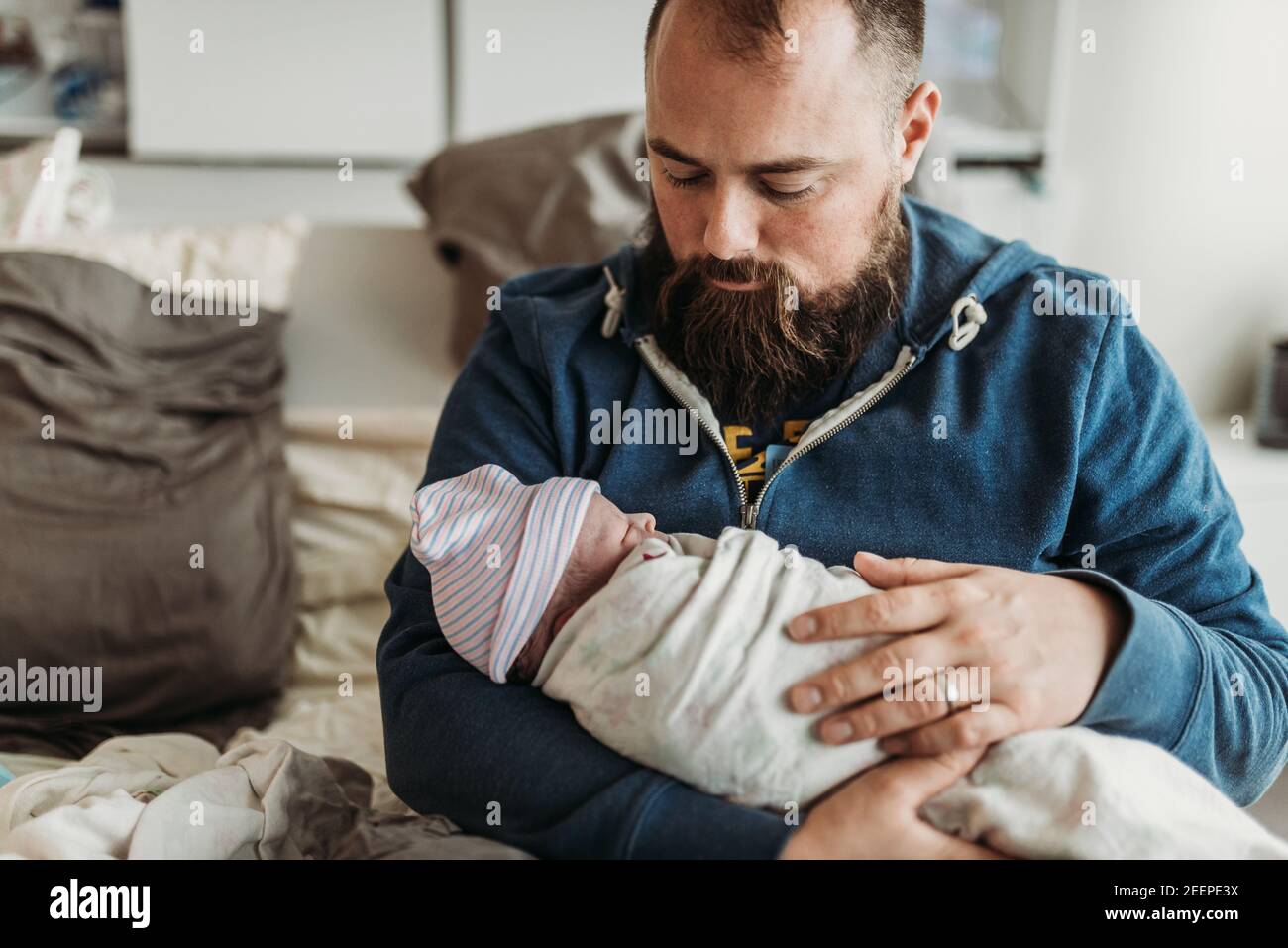 Father holding newborn baby boy right after birth in hospital Stock Photo