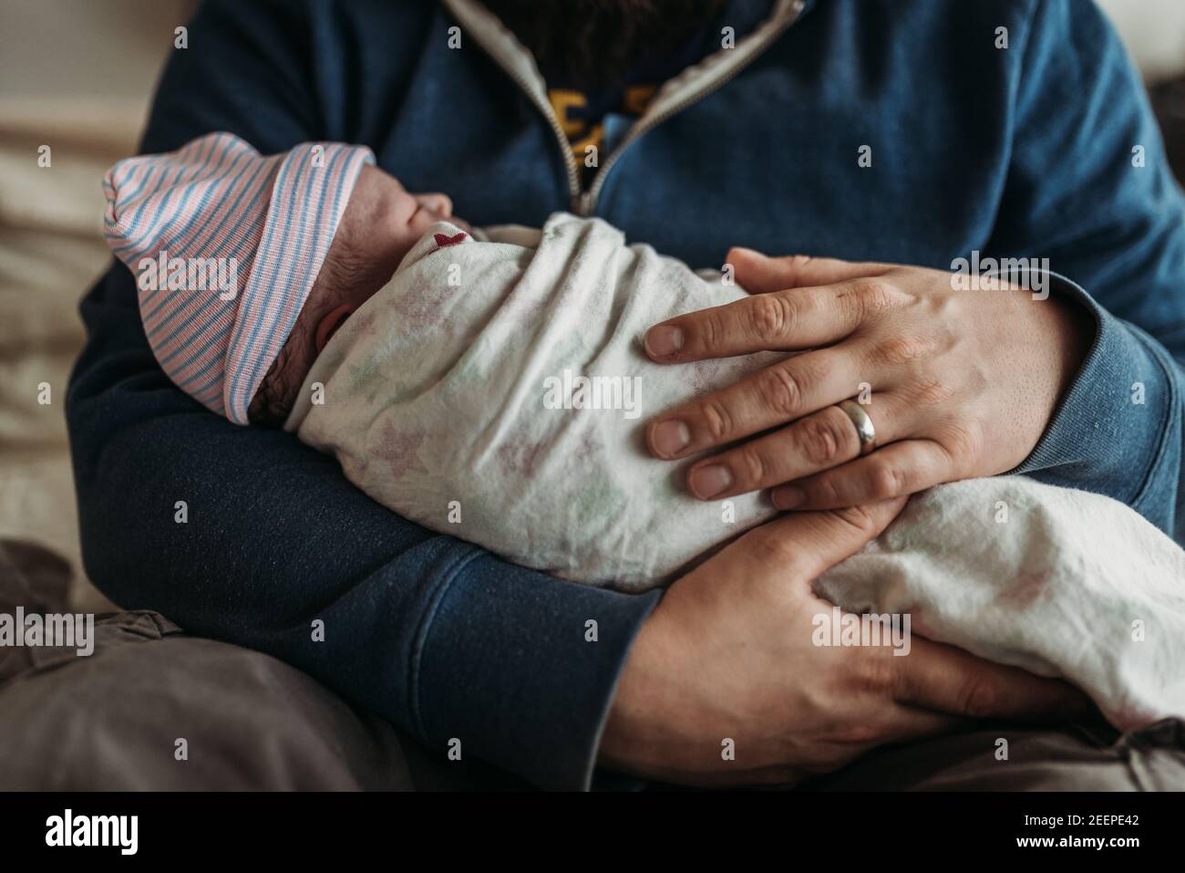 Close up image of fathers hands holding newborn son right after Stock Photo