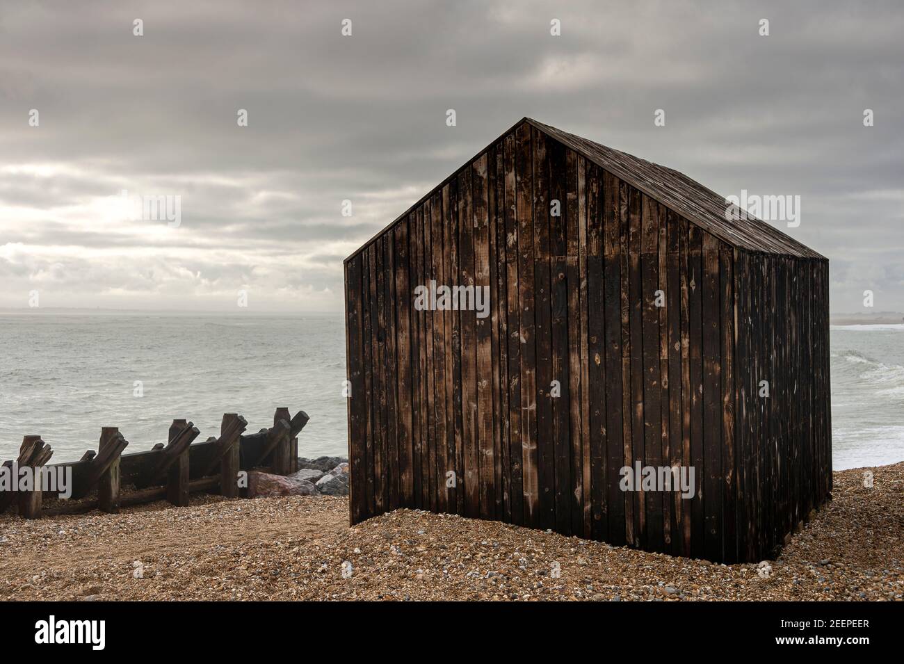 Beach hut on Hayling Island, made from treated burnt wood. Stock Photo