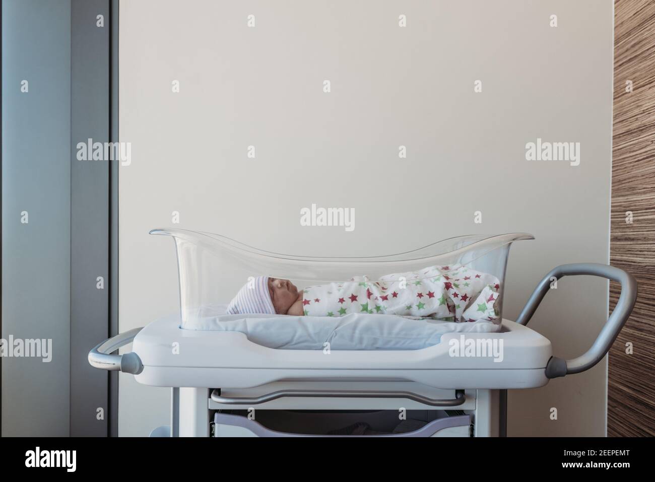 newborn baby boy in wrapped in hospital blanket Stock Photo